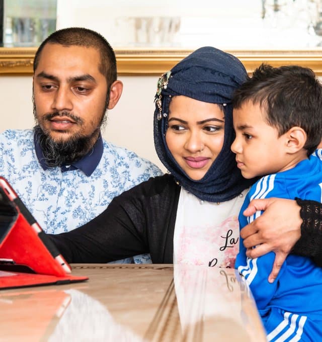 A family looking at a tablet
