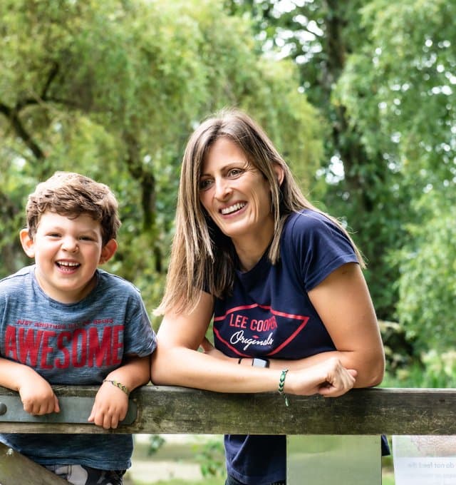 Women and boy smiling outdoors