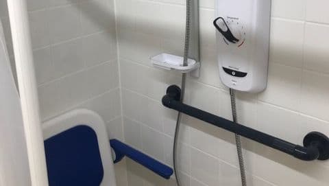 Minor - shower unit with contrasting colour control & rail for visual impairment